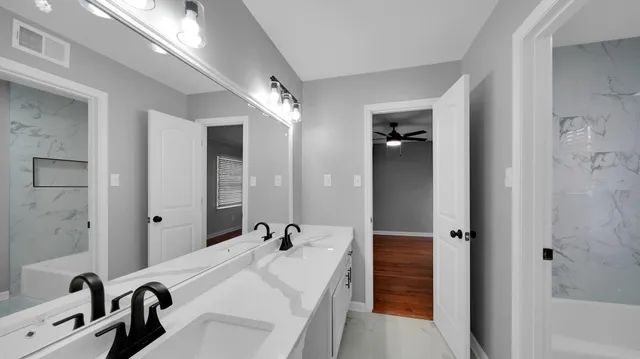 a bathroom with a sink and mirror