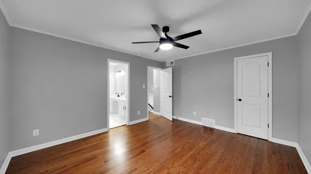 a view of an empty room and wooden floor