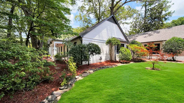 a view of a house with a yard and sitting area