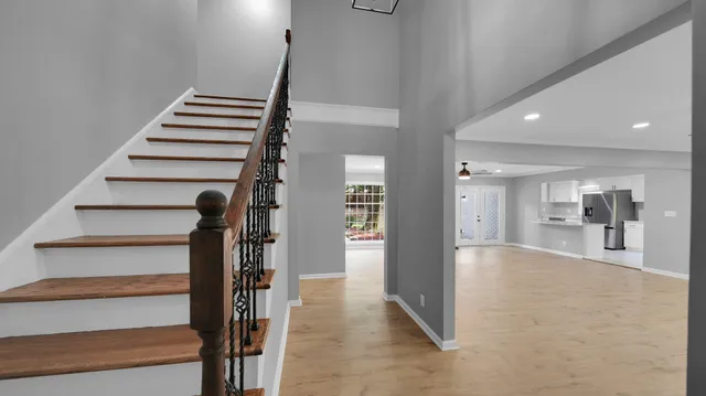 a view of entryway and hall with wooden floor