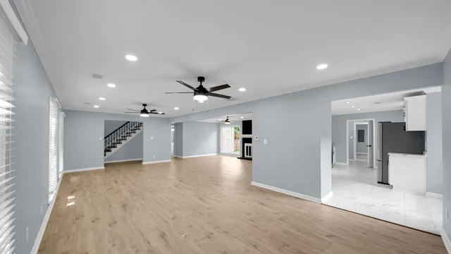 a view of an empty room and a ceiling fan