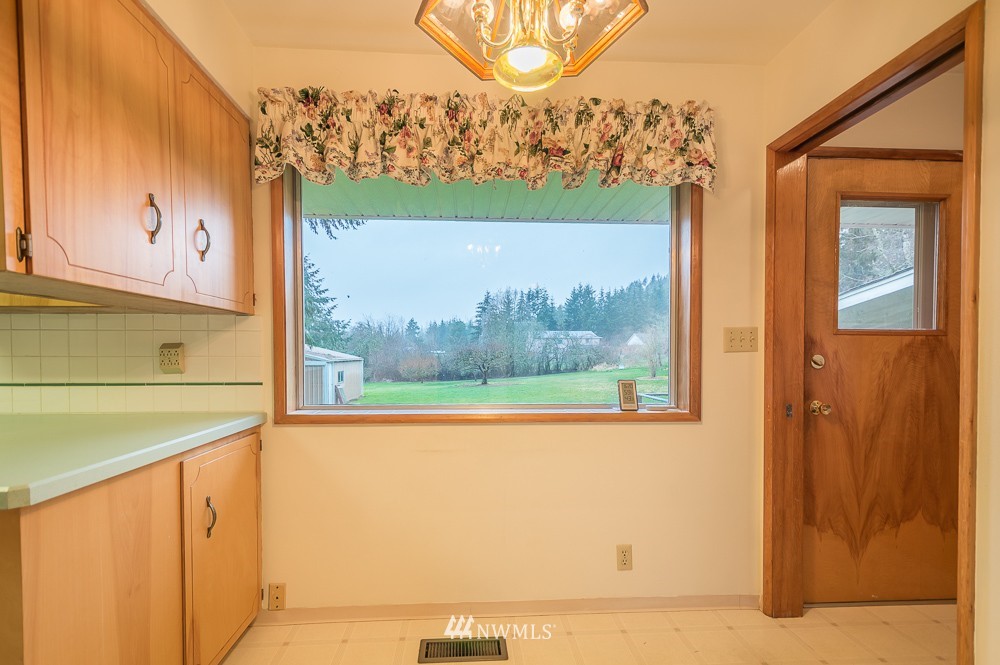 109 Kennicott Road Chehalis, WA 98532 - Photo 13 of 23 a view of a two room with a large window and front door
