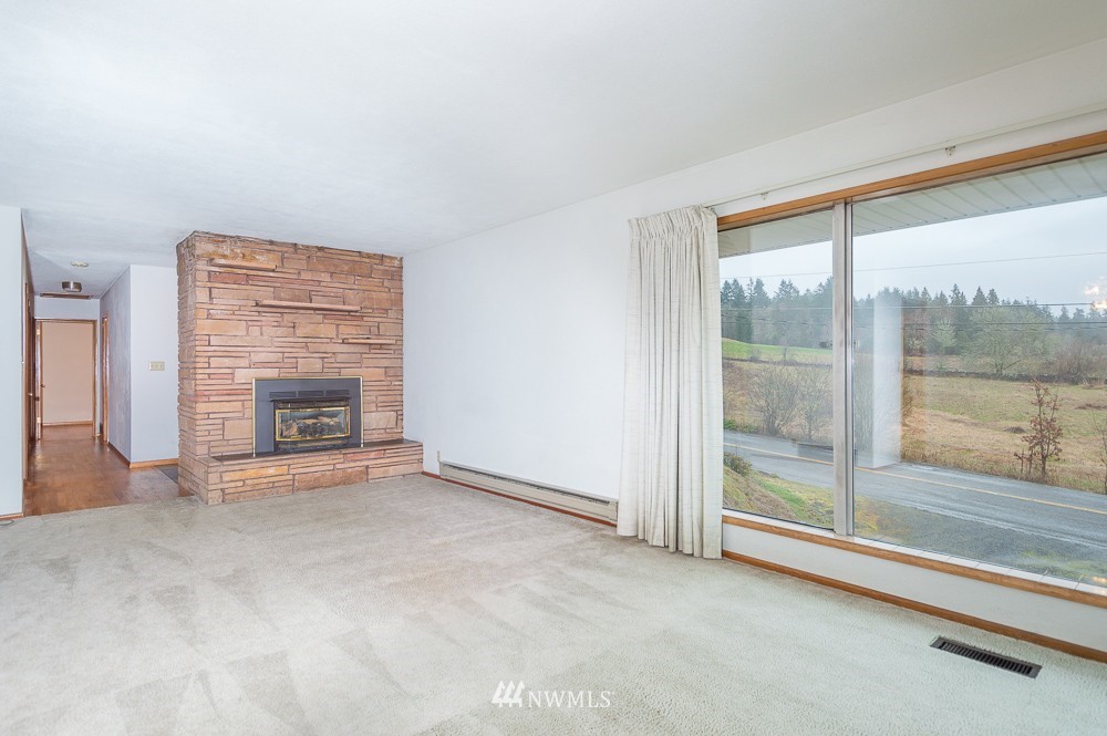109 Kennicott Road Chehalis, WA 98532 - Photo 9 of 23 a view of an empty room with a fireplace and a window