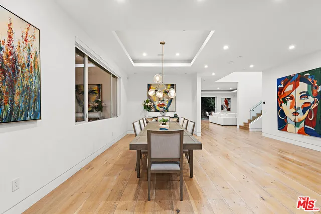 a dining room with furniture a rug and wooden floor