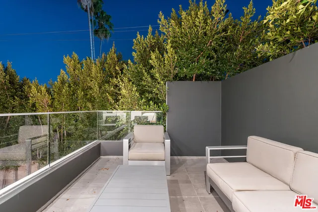 a view of a two chairs in the balcony