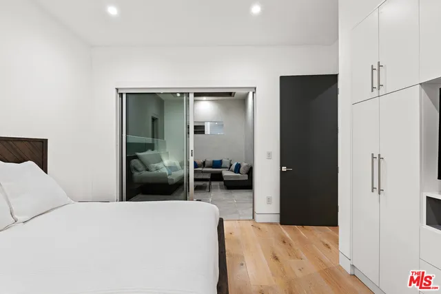 a bedroom with a bed and a television