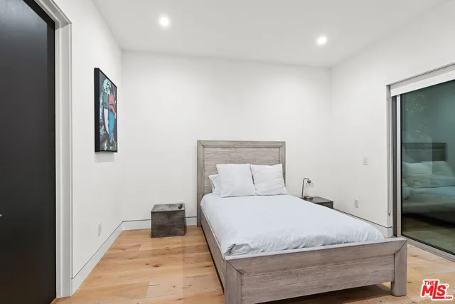 a bedroom with a bed and glass door