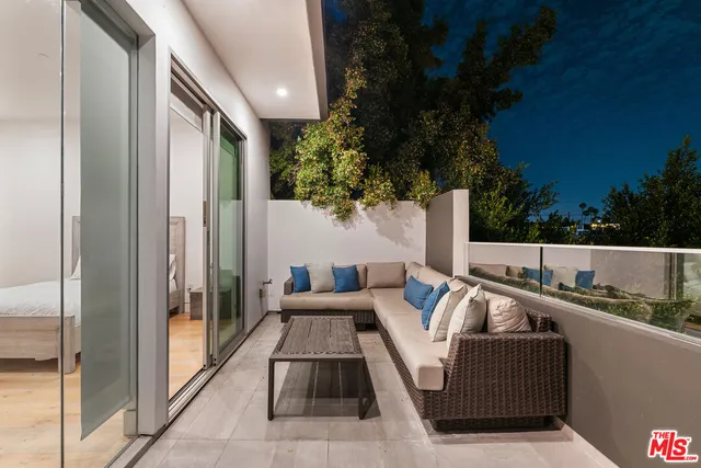 a view of a balcony with furniture