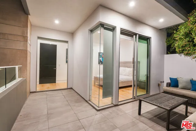 a bedroom with a bed and a night stand