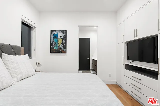 a bathroom with a painting on the wall and shower