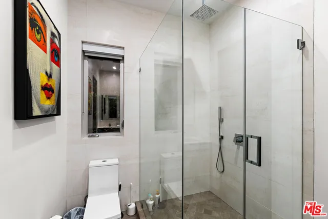 a bedroom with a bed and a lamp