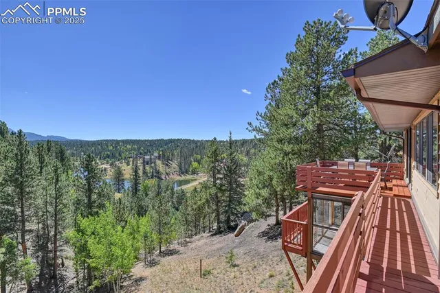 a view of a balcony with wooden floor and outdoor space