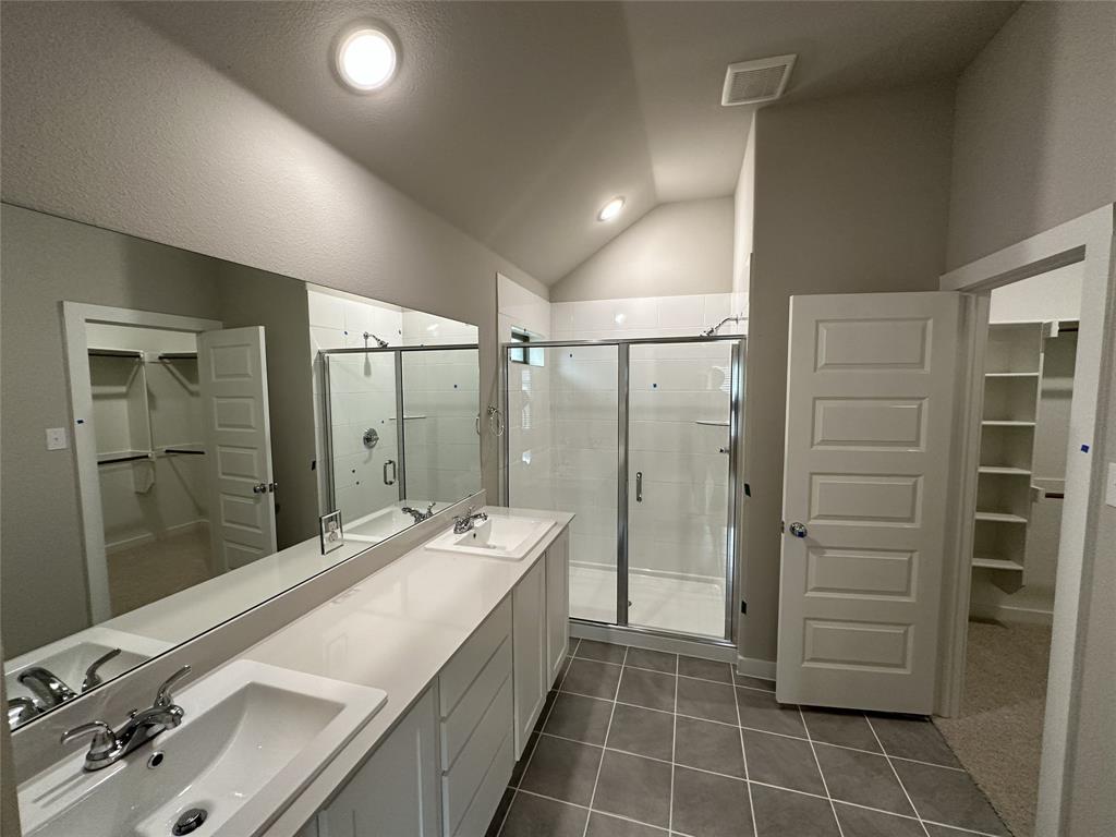 109 Lavender Street Forney, TX 75126 - Photo 7 of 15 a bathroom with a granite countertop sink a mirror and a shower