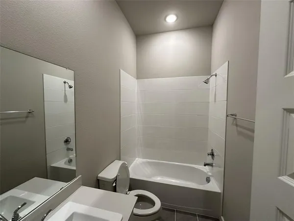 a bathroom with a tub a sink and a shower
