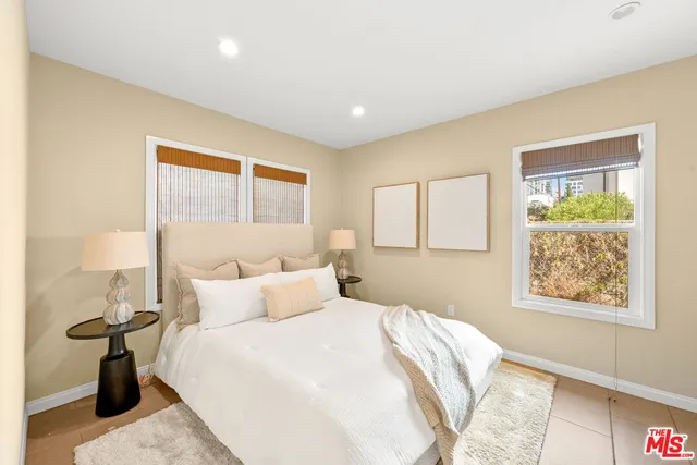 a bedroom with a bed and a window