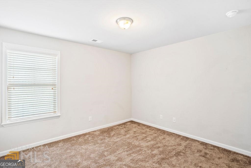 7704 Fawn Circle Covington, GA 30014 - Photo 11 of 14 a view of a room with a window