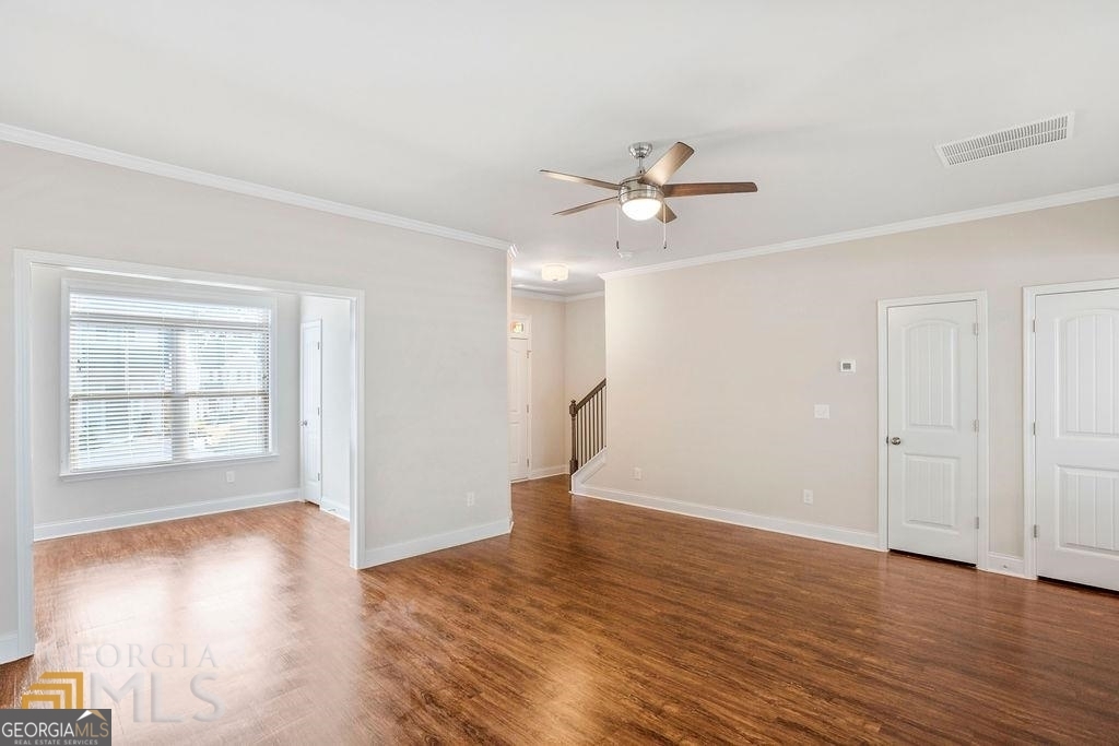 7704 Fawn Circle Covington, GA 30014 - Photo 3 of 14 an empty room with wooden floor and windows