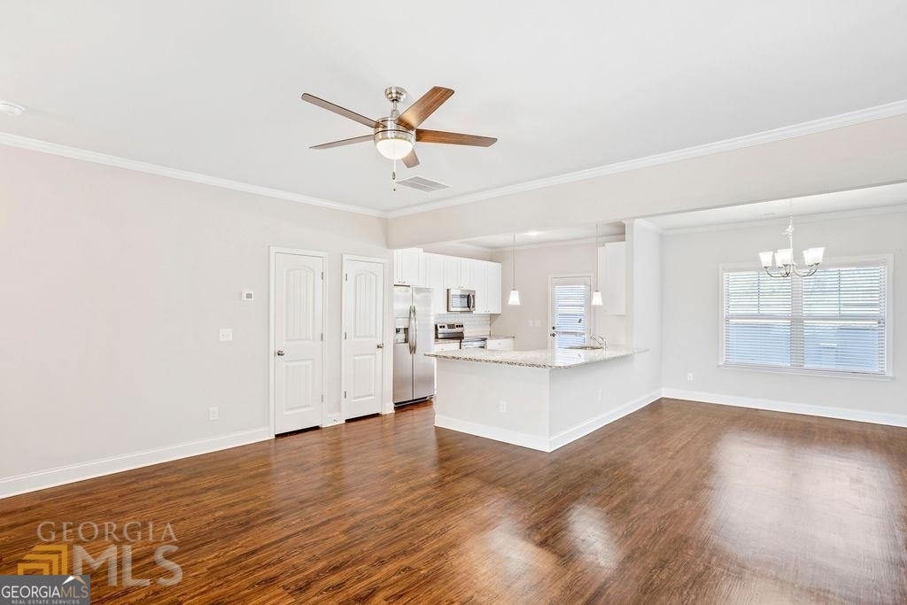 7704 Fawn Circle Covington, GA 30014 - Photo 4 of 14 a view of a kitchen with wooden floor and a window