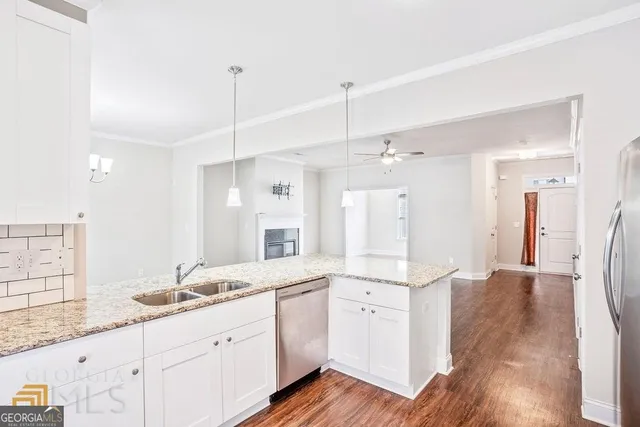 a large bathroom with a granite countertop double vanity sink a mirror and shower