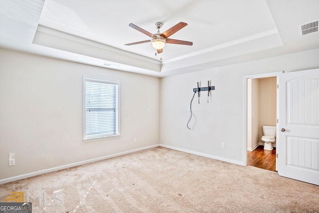 7704 Fawn Circle Covington, GA 30014 - Photo 9 of 14 a view of a livingroom with a ceiling fan & windows