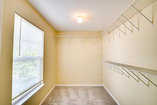 a view of a room with racks on the wall and a window