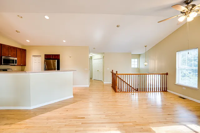 a view of a room with furniture and wooden floor