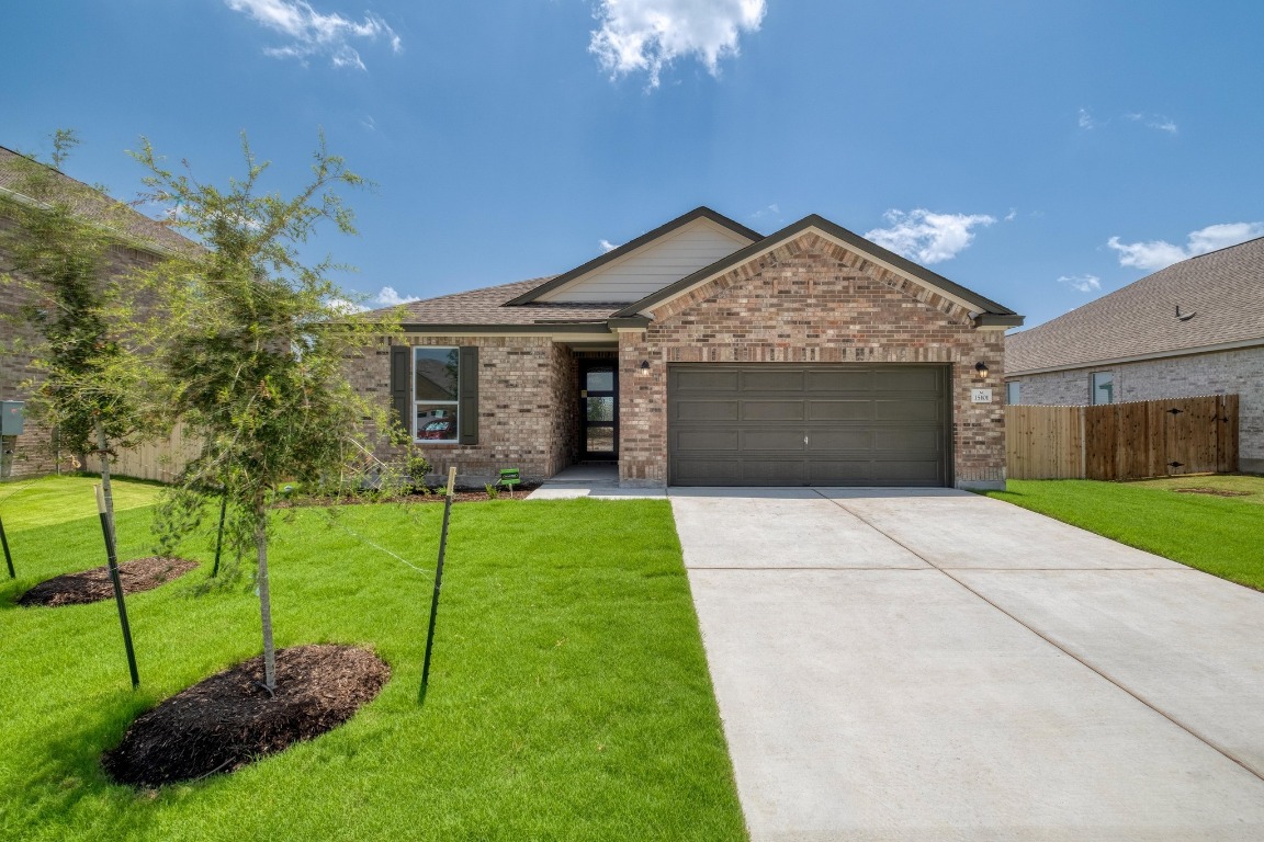 15101 Onager Pass Manor, TX 78653 - Photo 1 of 1 a view of a house with a yard and a garden