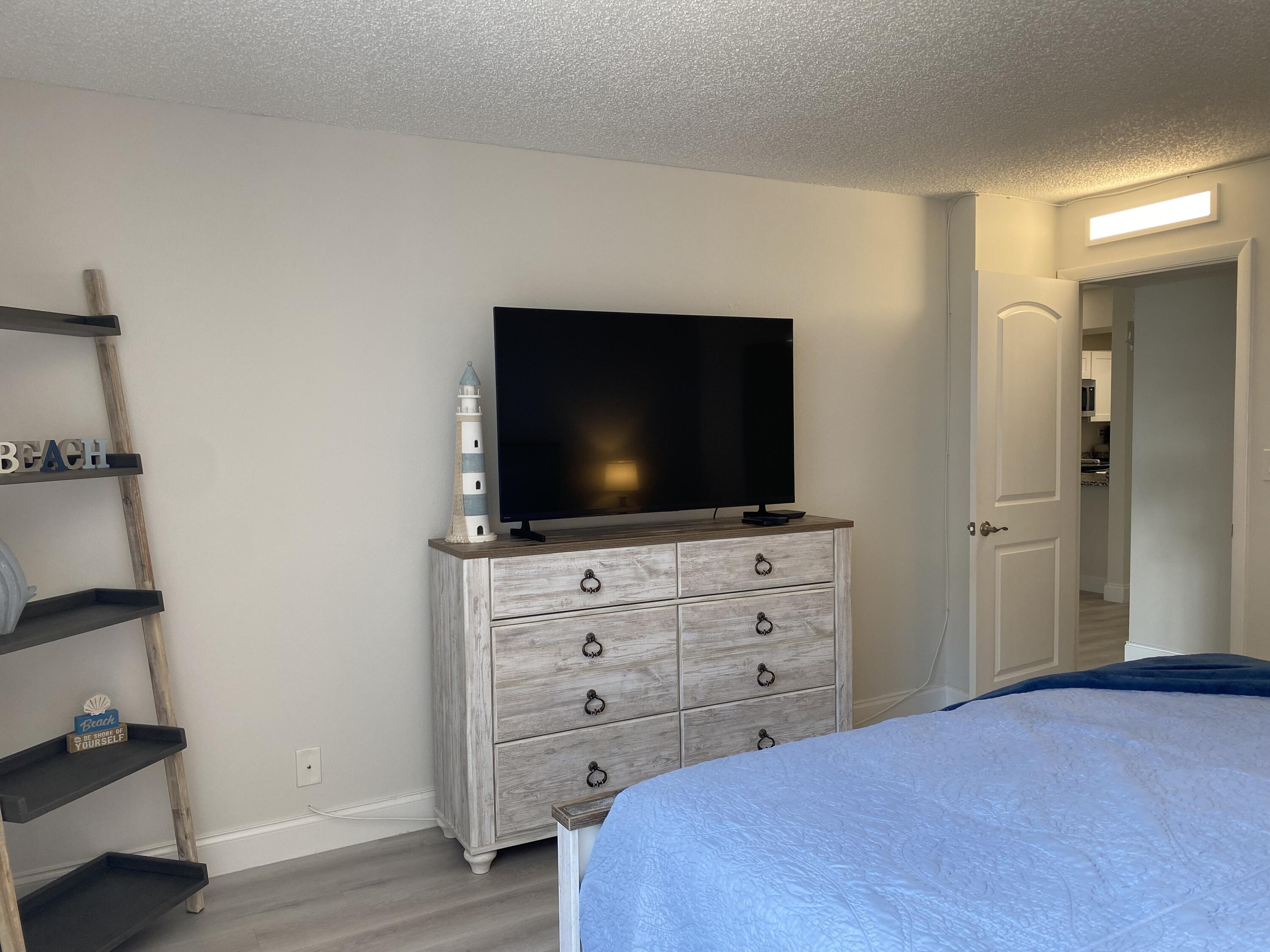8 Royal Palm Way, Unit 107 Boca Raton, FL 33432 - Photo 25 of 75 Primary Bedroom Large screen TV