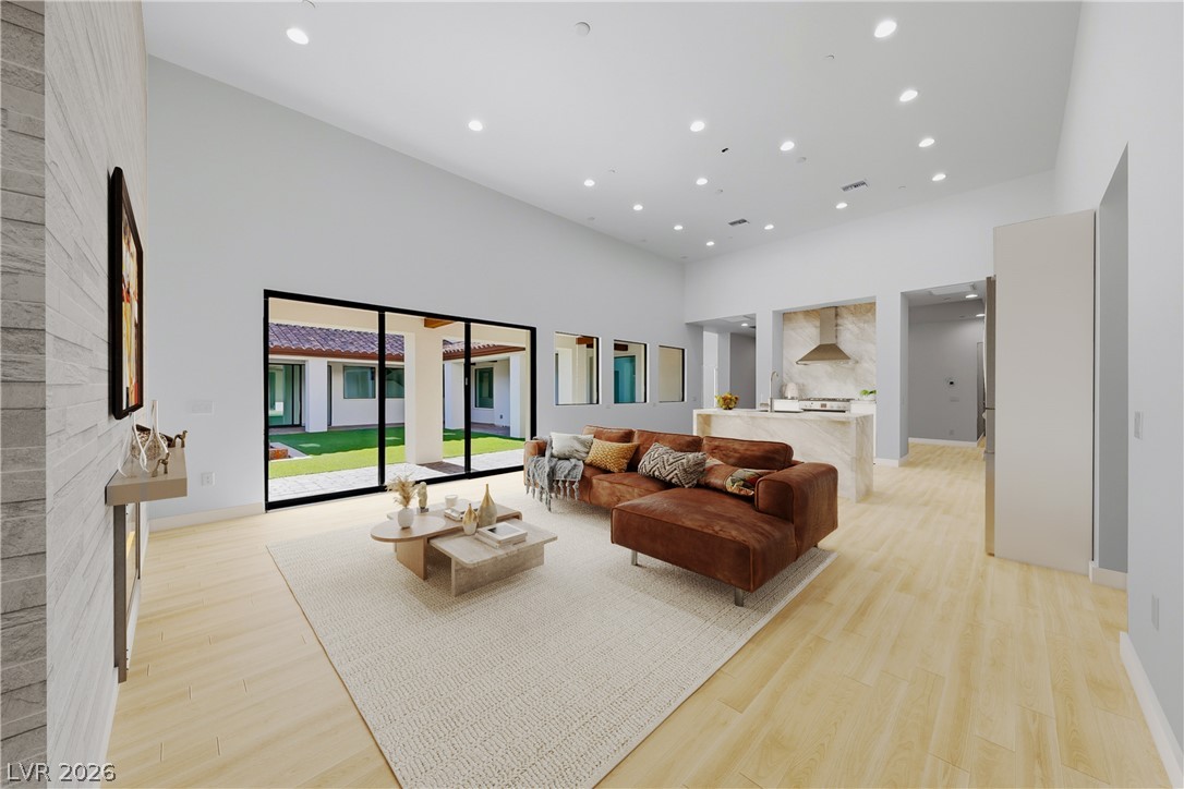 1140 Julie Road Henderson, NV 89002 - Photo 40 of 71 Virtually staged/remodeled. 1140 JULIE RD HENDERSON NV 89002. A spacious living area seamlessly transitions to a beautiful outdoor space through expansive glass doors.