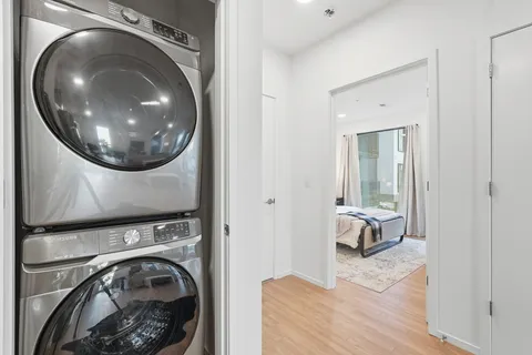 a view of a bedroom with washer and dryer