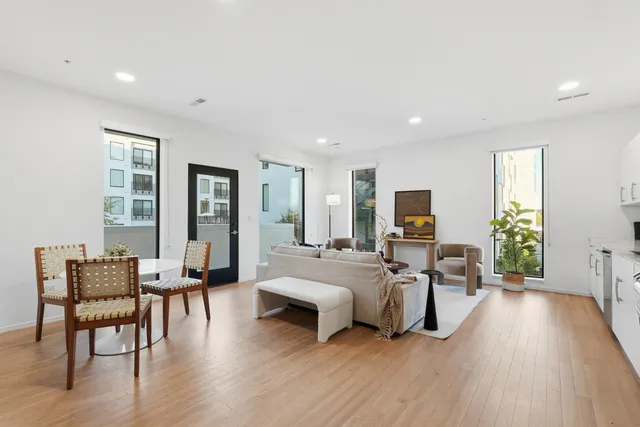 a living room with furniture flat screen tv and wooden floor