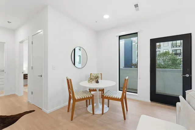 a dining room with furniture and a mirror