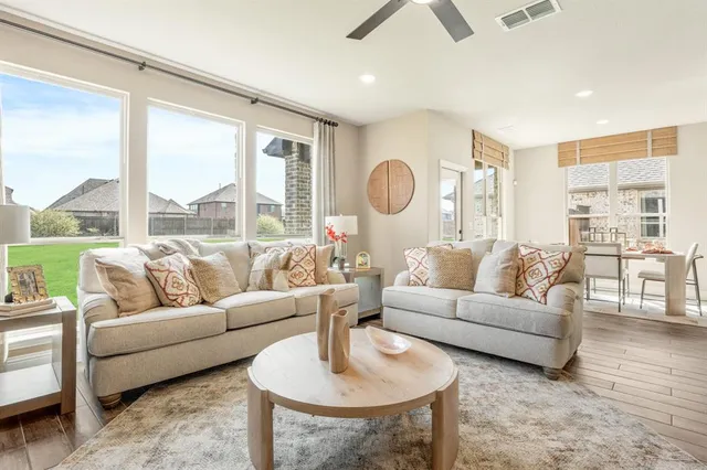 a living room with furniture and a large window