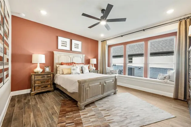 a bedroom with a large bed and a large window