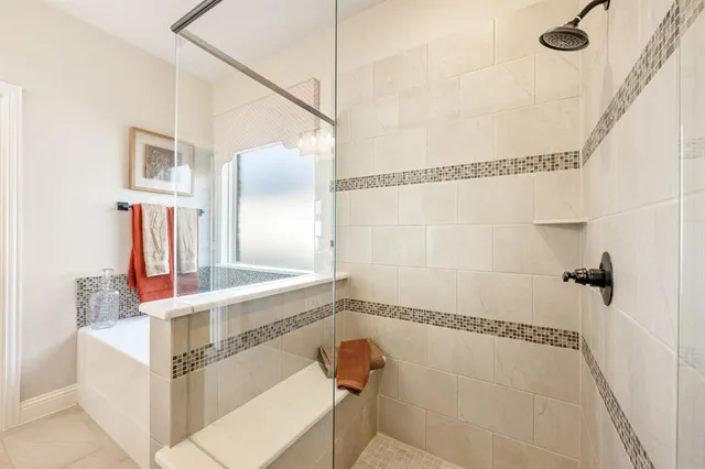 a bathroom with a bathtub and shower