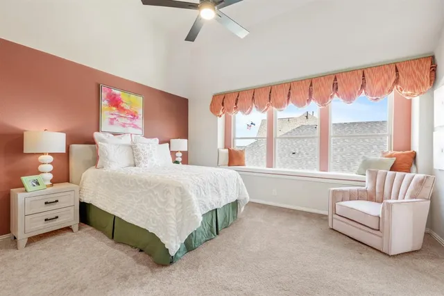 a spacious bedroom with a bed and a couch