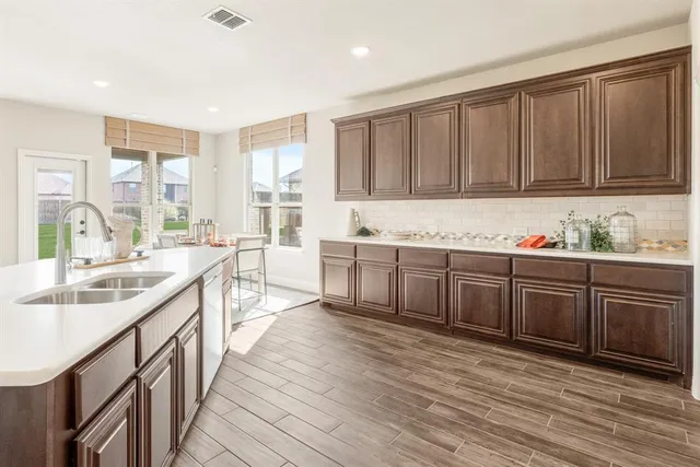 a kitchen with stainless steel appliances granite countertop a sink stove and cabinets