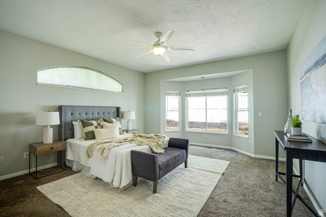 1433 Forge Way Draper, UT 84020 - Photo 14 of 29 Spacious room featuring a large bay window, arched transom window, and ceiling fan