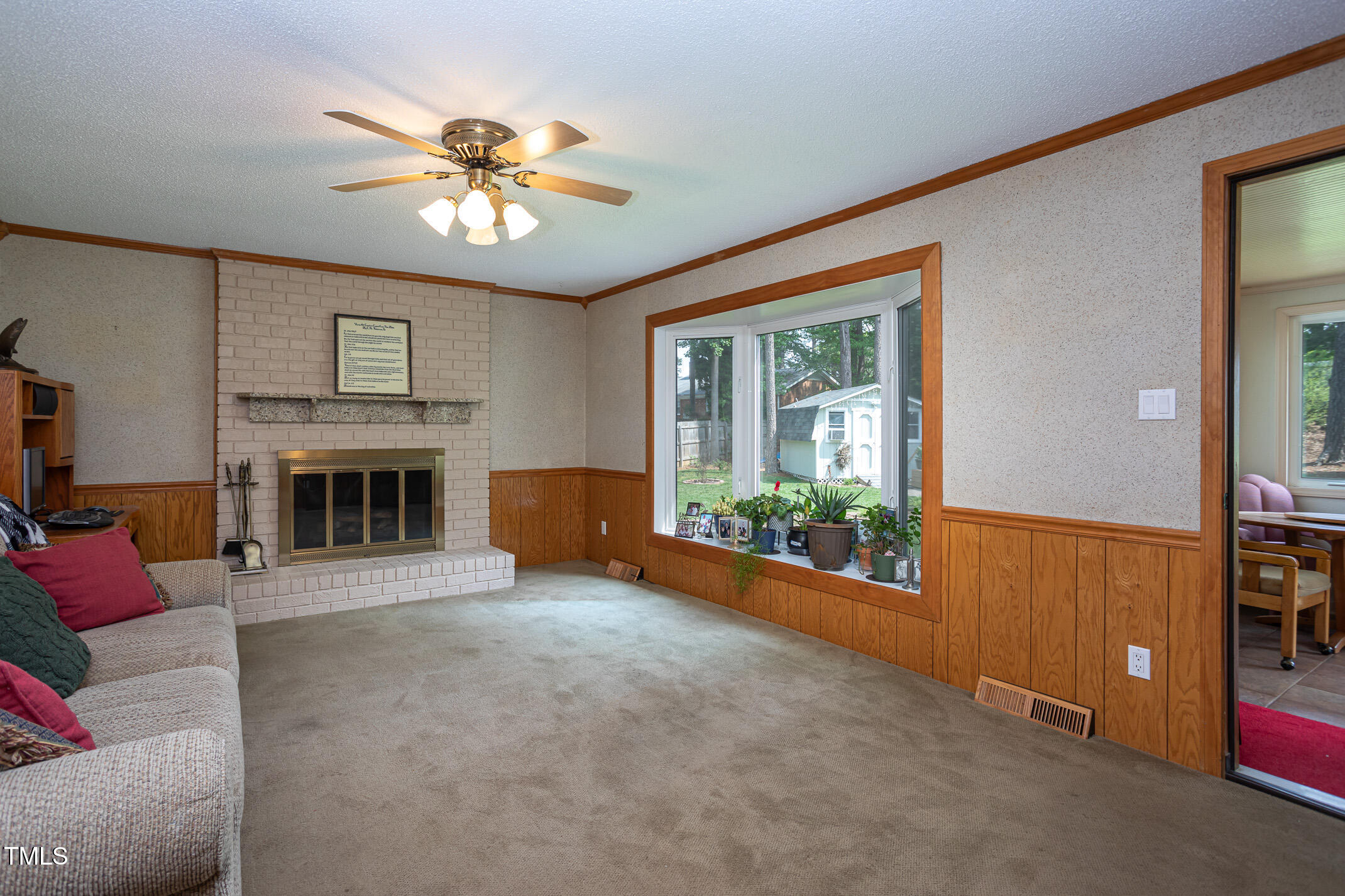 1213 Indian Trail Drive Raleigh, NC 27609 - Photo 13 of 50 a view of a livingroom with a ceiling fan and window