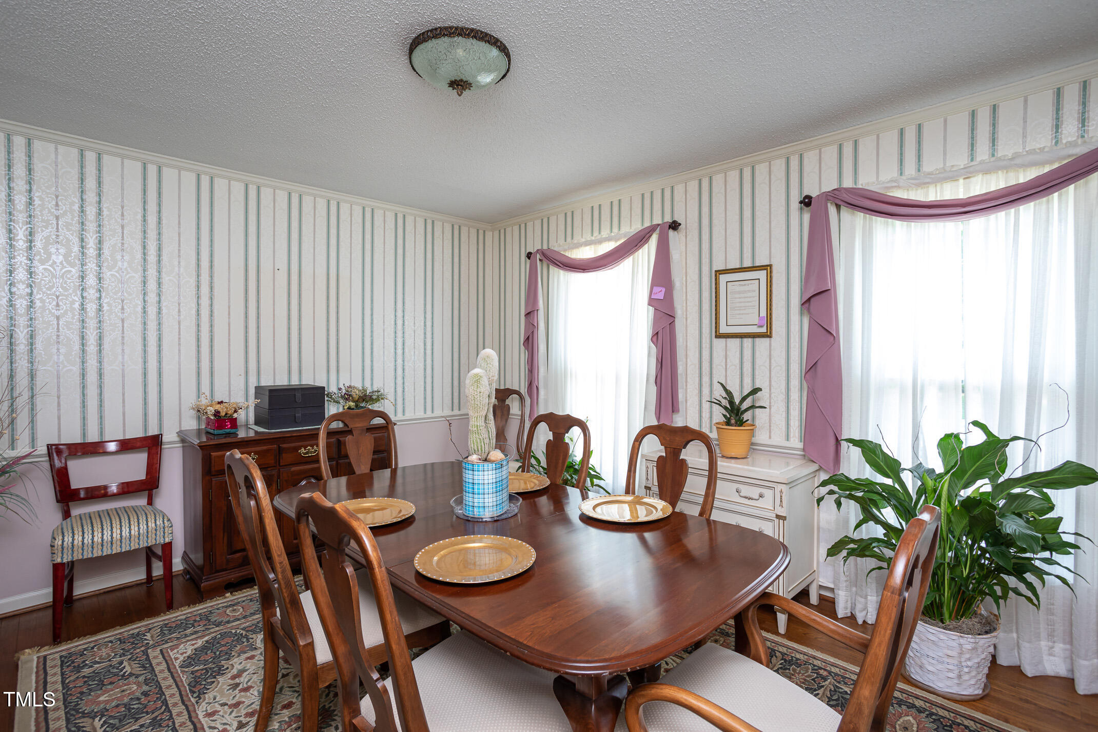 1213 Indian Trail Drive Raleigh, NC 27609 - Photo 14 of 50 a view of a dining room with furniture window and wooden floor