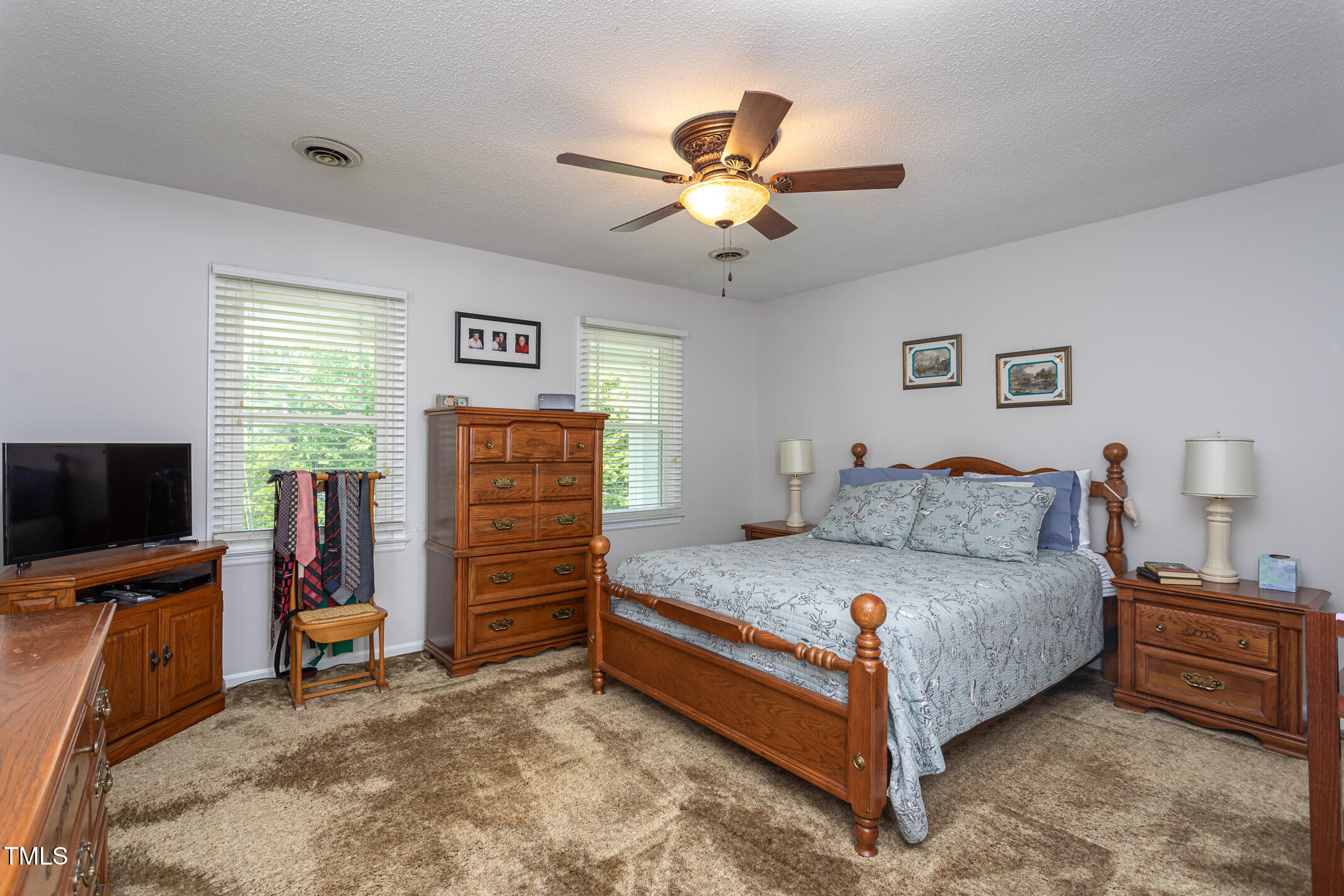 1213 Indian Trail Drive Raleigh, NC 27609 - Photo 20 of 50 a bedroom with a bed and a flat screen tv