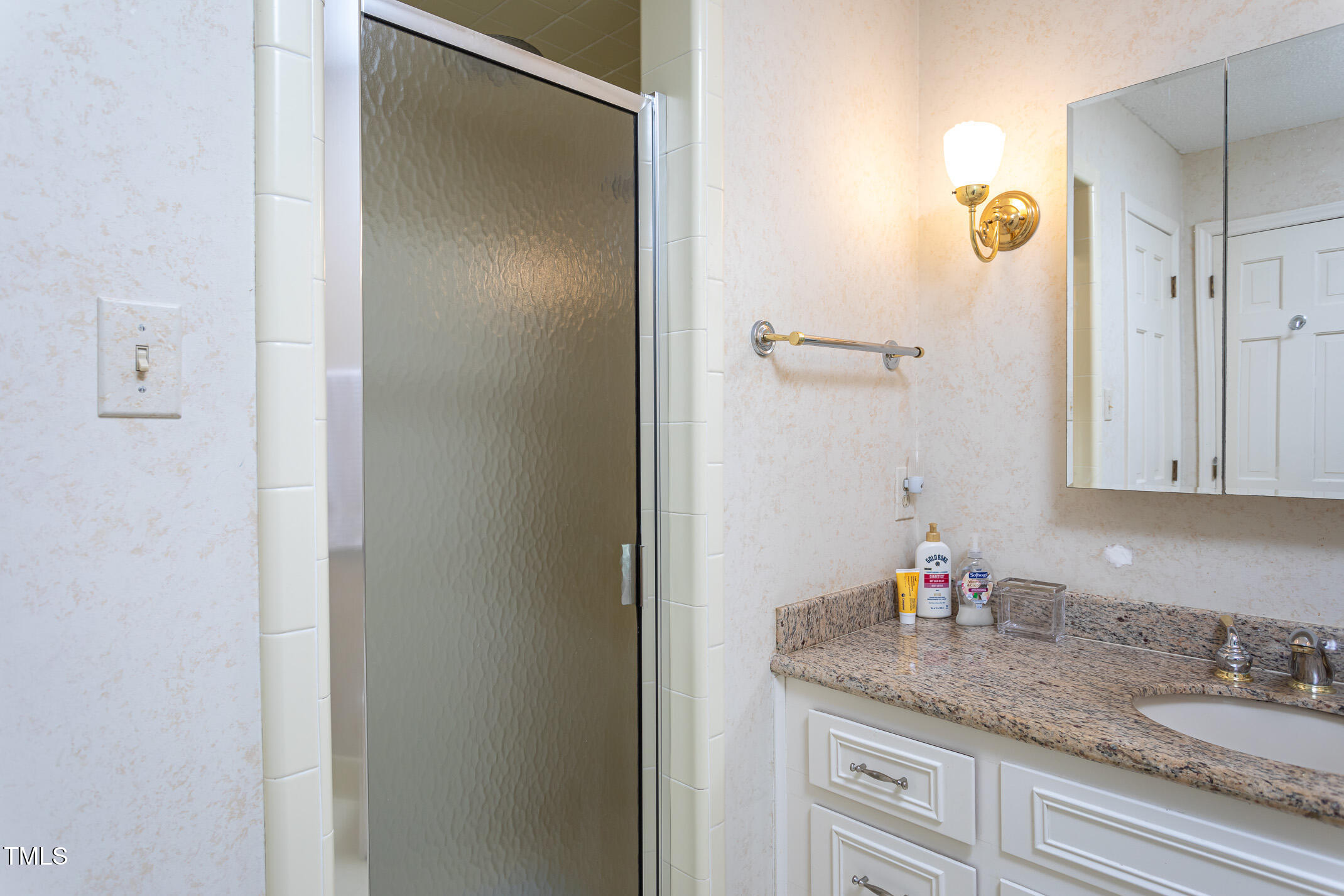 1213 Indian Trail Drive Raleigh, NC 27609 - Photo 22 of 50 a bathroom with a granite countertop sink and a mirror