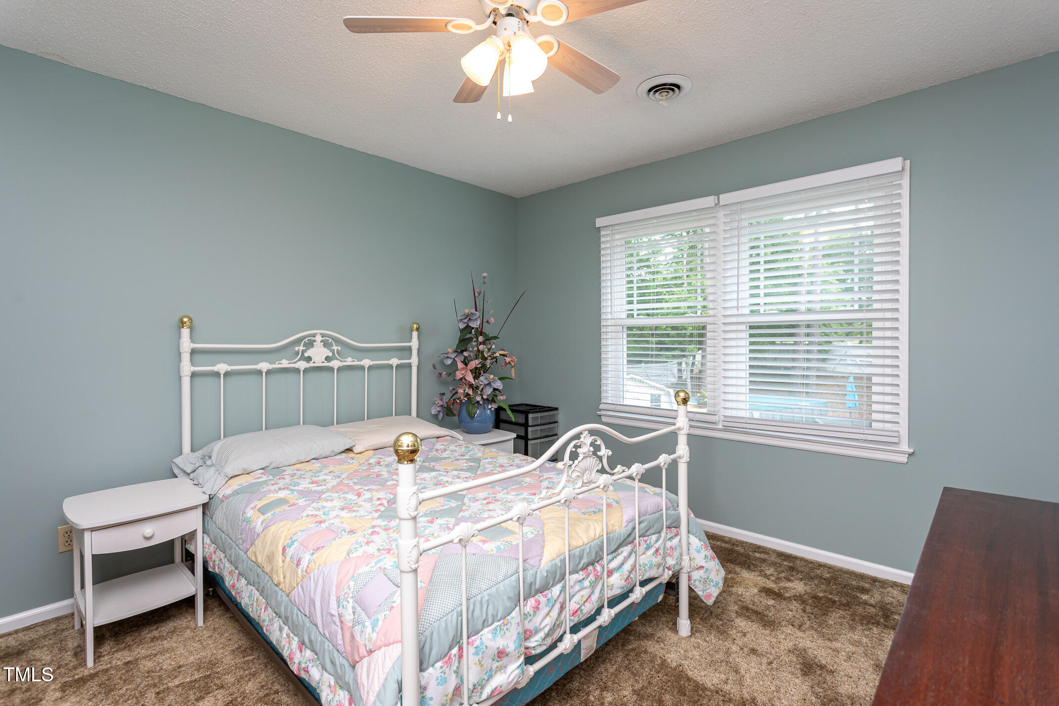 1213 Indian Trail Drive Raleigh, NC 27609 - Photo 25 of 50 a bedroom with a bed and a chandelier