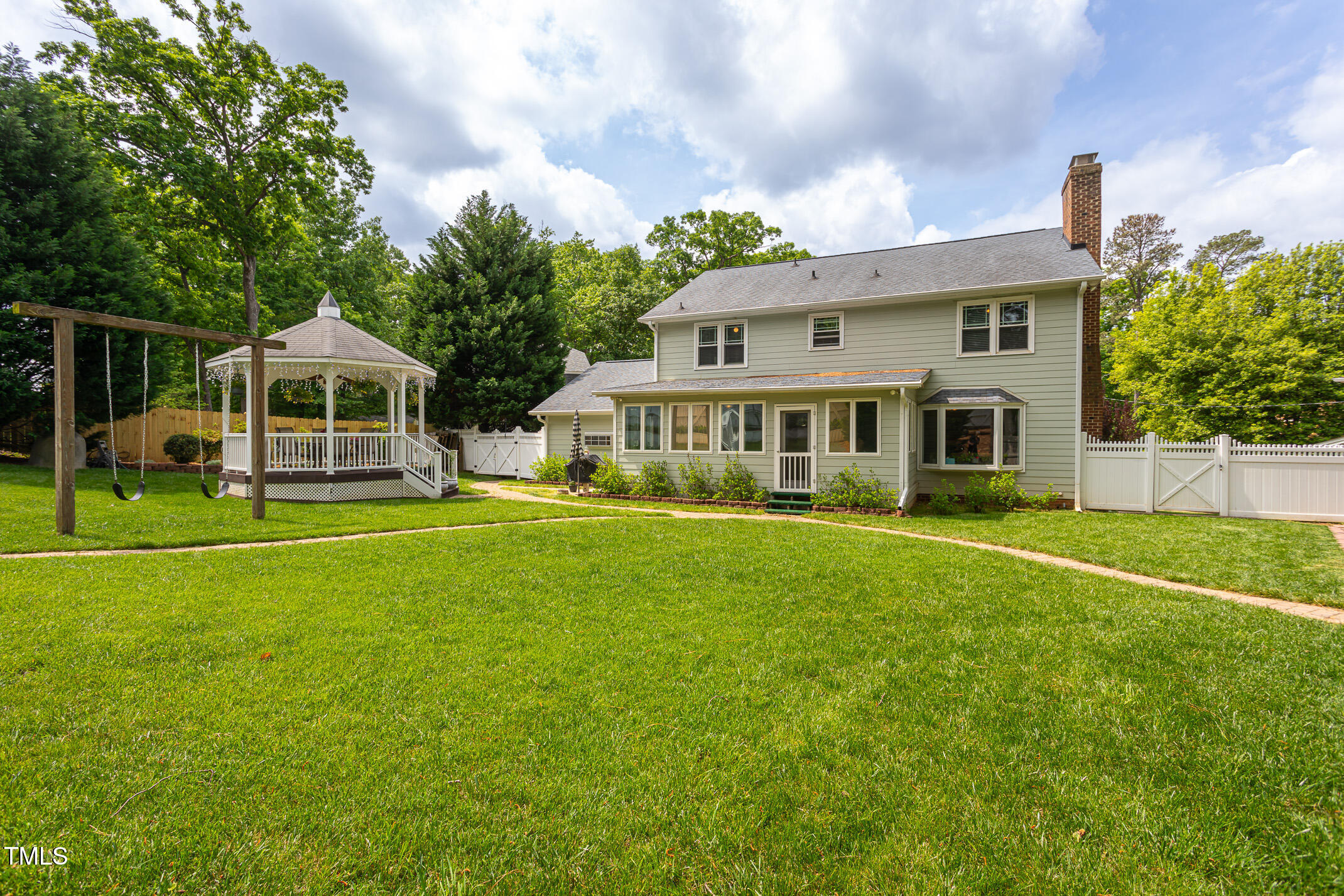 1213 Indian Trail Drive Raleigh, NC 27609 - Photo 36 of 50 a front view of a house with a yard table and chairs