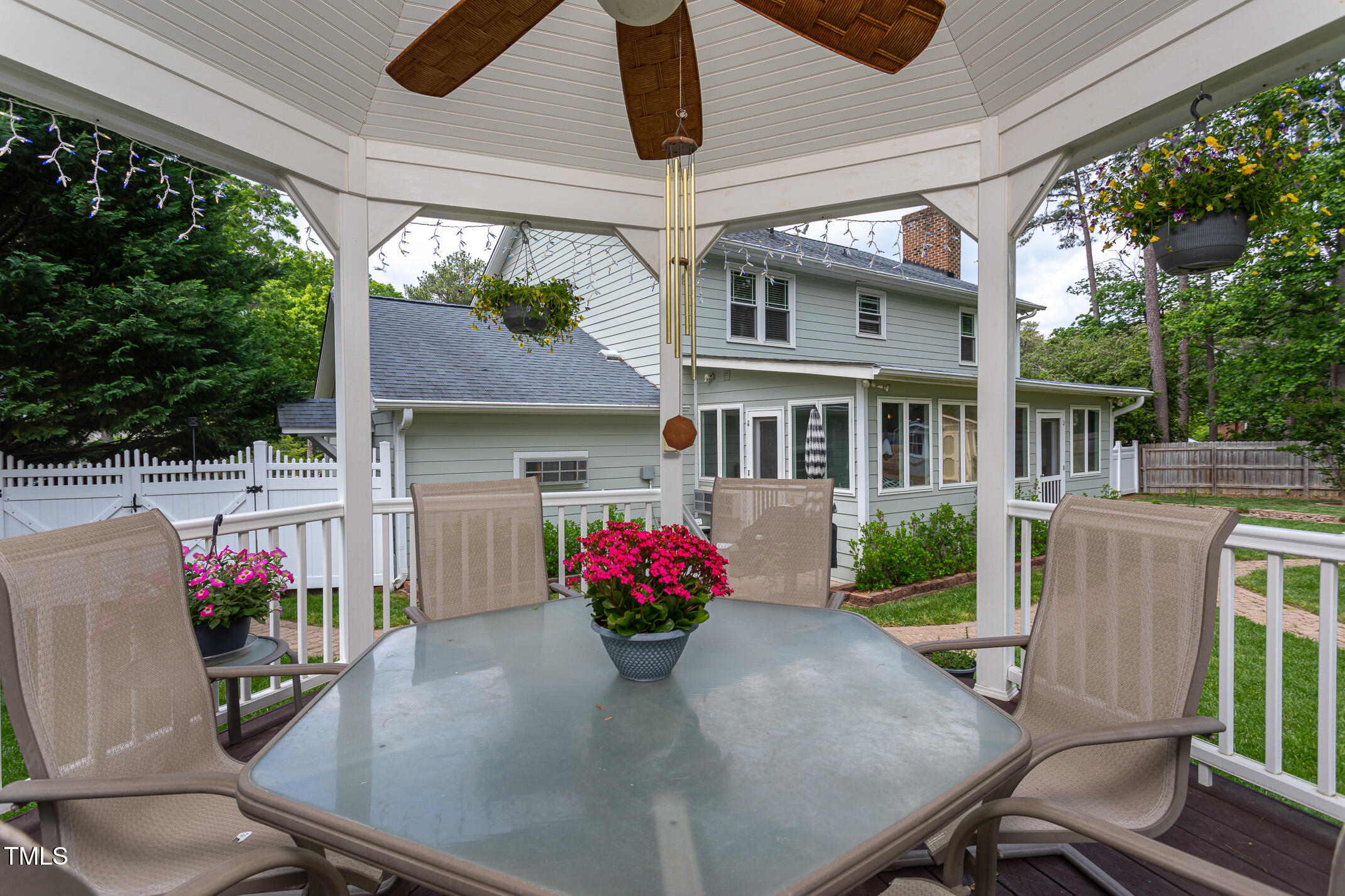1213 Indian Trail Drive Raleigh, NC 27609 - Photo 39 of 50 a view of a patio with a table and chairs potted plants