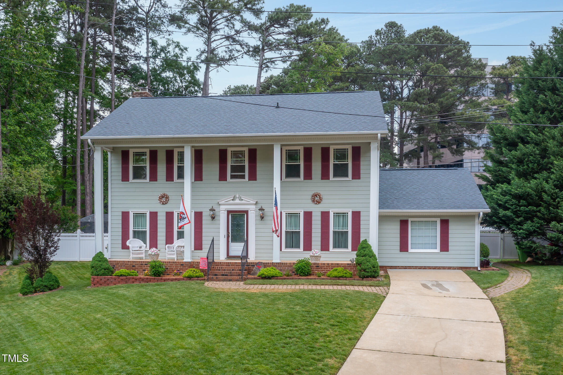 1213 Indian Trail Drive Raleigh, NC 27609 - Photo 43 of 50 front view of a brick house with a yard