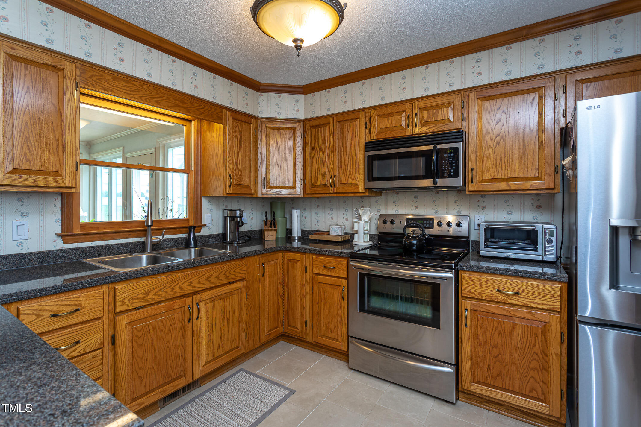 1213 Indian Trail Drive Raleigh, NC 27609 - Photo 7 of 50 a kitchen with stainless steel appliances granite countertop a stove sink and microwave