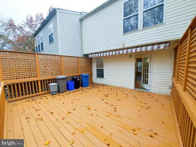a view of a house with a wooden fence