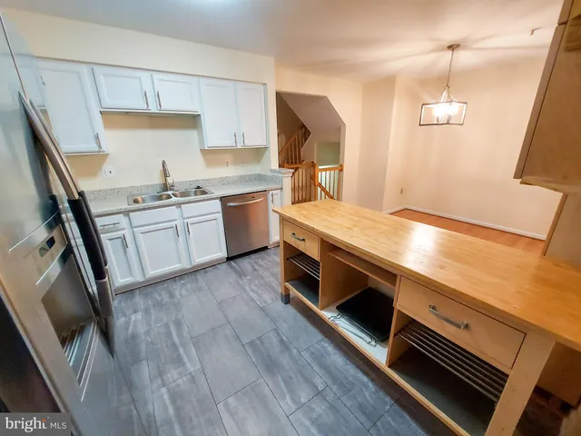 a kitchen with a stove a sink and a refrigerator
