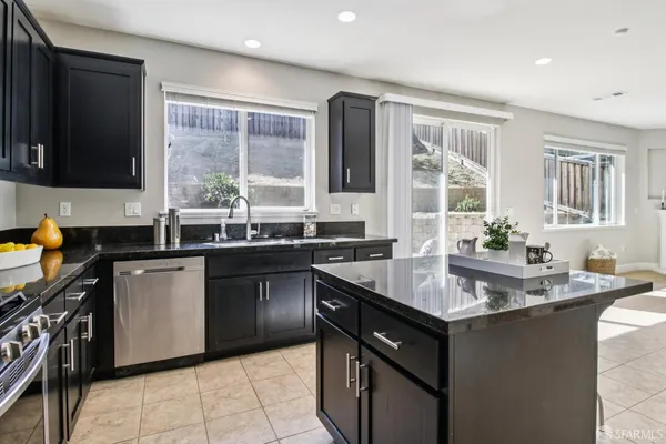a kitchen with a sink stove and cabinets